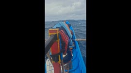 Rowing boat battles through huge swells off the coast of island