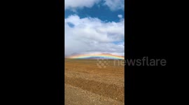 Stunning moment rainbow appears to rest on remote Tibetan mountain