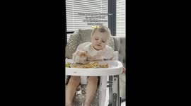 Eat or sleep? Adorable toddler won't let her tiredness stop her from snacking