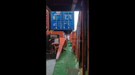 Seawater surges onto container ship traversing choppy conditions