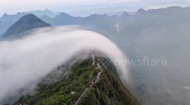 Rare 'cloud waterfall' cascades down mountain in China