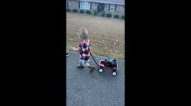 Kid dressed as Joe Dirt walks with cart on Halloween in Bremen, Kentucky