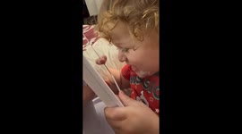 Baby kisses himself on a mirror