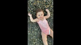 Baby gently lifted by wave on the shore in İzmir, Turkey