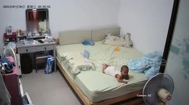 Grandad with superhuman reflexes dives to catch baby falling head-first off bed