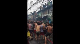 Locals scramble for pieces of copper wire as fire ravages their homes