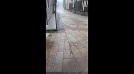 Heavy rain soaks concrete streets in Kanazawa, Japan
