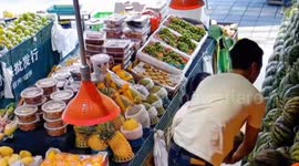 Shopkeepers battle to stop dozens of watermelons falling from shelf
