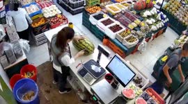 Shopkeeper startled by watermelon squirting water in her face