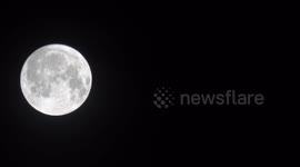 The August Full Moon known as the Sturgeon Full Moon high in the sky in East London