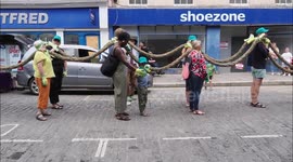 Artists walk giant shipping rope through Kent high street, UK