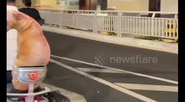 Fake dog taped to electric motorcycle surprises on road in Henan, China