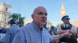 An angry pro-Palestine protester makes his feelings about the police at the Defend Our Juries  protest in Parliament Square