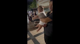 Baby dances happily to upbeat music at a park in Henan, China