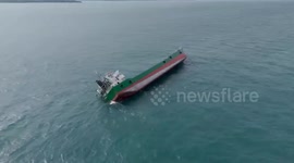 Cargo ship capsizes in choppy sea as all crew are rescued