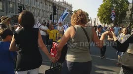 People join in a circle dance as a Jewish song plays at the National March for the Hostages, organized by 'Stop the Hate UK' and other British Jewish organizations