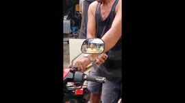 Motorcycle rider finds python coiling inside his engine