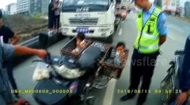 Four people on motorcycle including two children in baskets