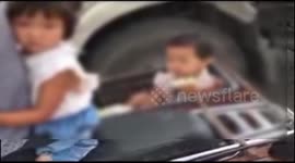 Four people on motorcycle including two children in baskets