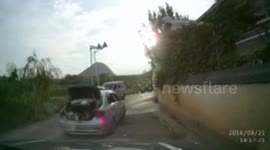 Four people travel in the open boot of a car in China