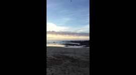Ominous rare roll clouds hover over Portreath beach Cornwall during Summer heatwave