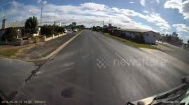 Car overtaking truck turning right into servo.