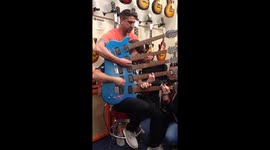 Three men perform on five-necked electric guitar
