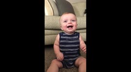 Baby can't stop laughing at mother tearing paper