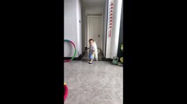 Child playfully walks with dog clinging on his back in Hubei, China