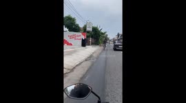 Cyclist seen casually riding backwards along the road
