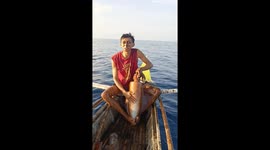 Squid squirts ink all over fisherman's face