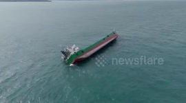 Cargo ship capsizes in choppy sea as all crew are rescued
