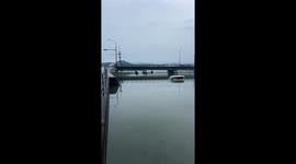 Floodwaters overflow from Lake Gozu onto the road in Kumamoto City, Japan