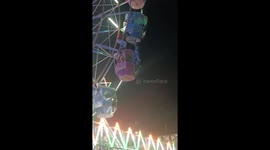 Woman hangs from gondola before being rescued at fairground