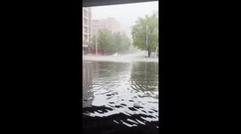 Hunky driver stands on car roof while stranded in floods in China