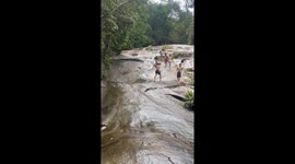 Boy slides into trouble during natural slide adventure, colliding with large rock