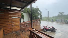 Rain and fierce winds batter streets as Typhoon Podul approaches Taiwan