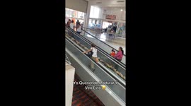 Lady walks upward on moving walkway without realizing it’s moving downward