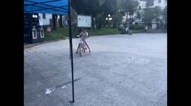 Girl’s first attempt at riding a bicycle in Guangxi, China