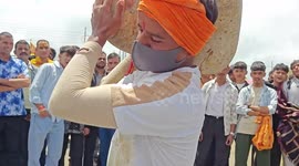 Indian strongmen compete in boulder lifting ritual at temple