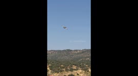 Spain: Water Bomber Scoops Water From Plasencia Reservoir