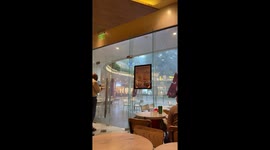 Storm blows signs into coffee shop in Manila