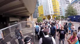 Anti Migrant protesters shout and swear at asylum seekers as they arrive and depart the Britannia International Hotel in Canary Wharf, East London