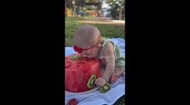 Toddler will do anything to get her teeth into juicy watermelon cake