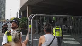 Anti-migrant protesters swear and shout 'Get back on your boat' while asylum seekers are being bussed out of the Britannia Hotel Canary Wharf