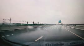 Car skids and spins on rainy highway in Guangdong, China