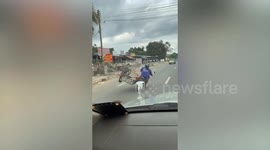 Rider tilts sidecar while driving on highway in Thailand