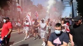 Anti Migrant protestors are arrested after blocking roads and setting off flares in Canary Wharf near the Britannia International Hotel