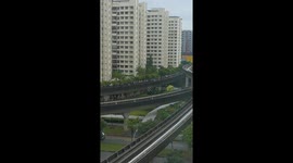 Passengers walk along train tracks after power fault in Singapore