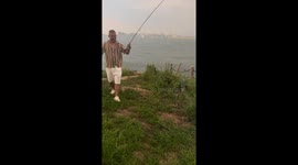 Man showcases cutlassfish glowing under flashlight in Hainan, China